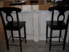 Black barstools with Deco white island